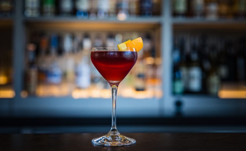 The Dark Side of Italy cocktail: Rye Whiskey, Sweet Vermouth, Campari, and Pistachio Oil.