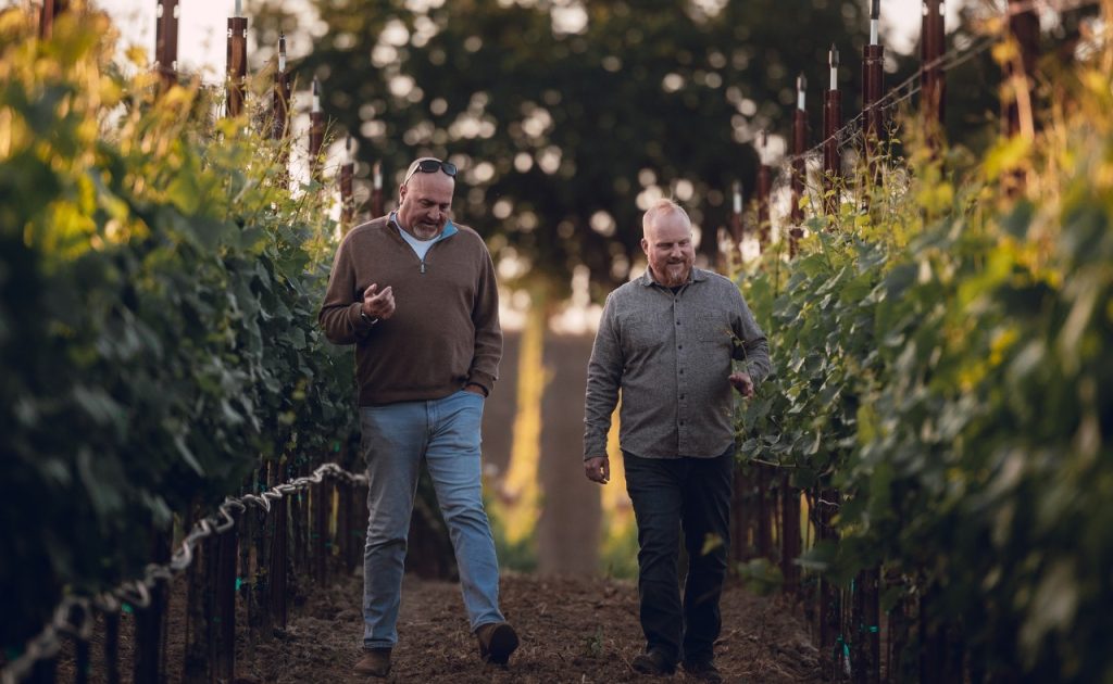 Founder Dan Kosta and winemaker Shane Finley walking in the vineyard.