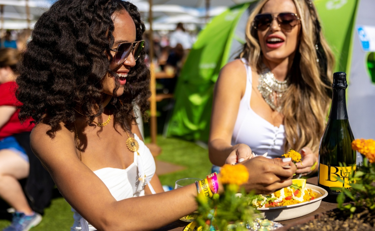 Two women eating food at BottleRock Napa Valley event.