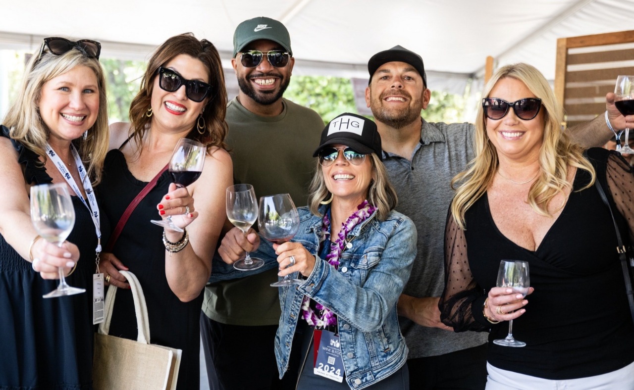 Guests posing for photo at Grand Tasting at Healdsburg Wine & Food Experience.