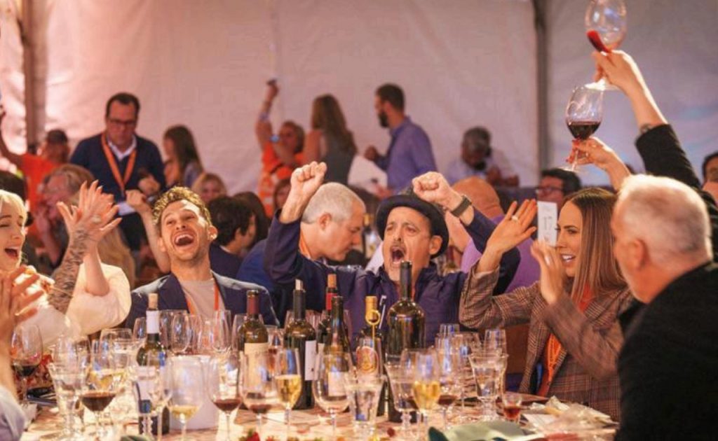 WineaPAWlooza guests cheering at auction.