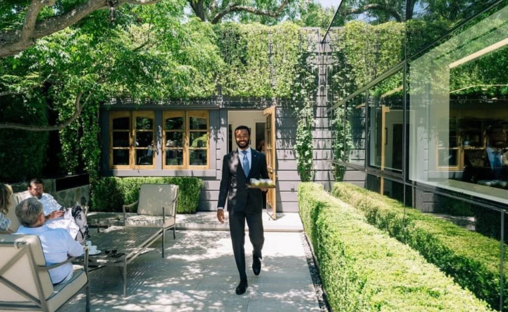 Server walking on The French Laundry restaurant patio.