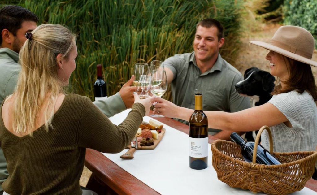 Guests holding dogs and glasses of wine at Matanzas Creek Winery.